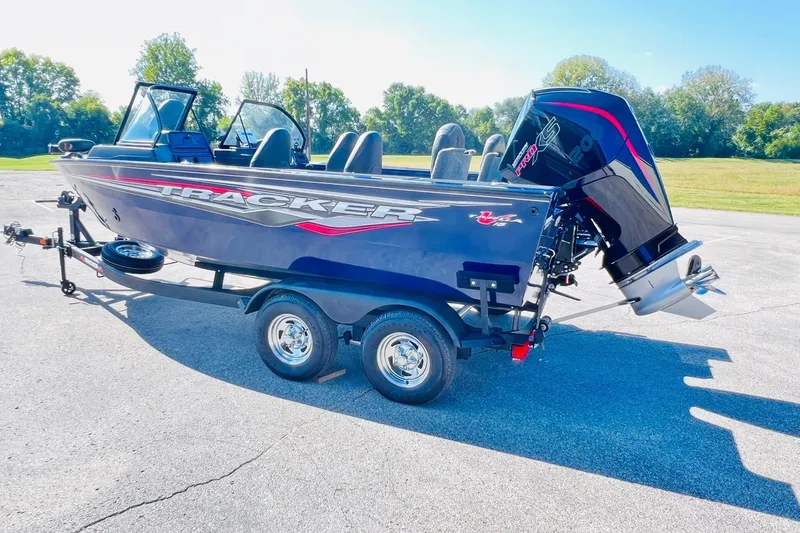 Slide: The Image of 2024 Tracker Targa V-18 Combo boat on trailer, parked outdoors in sunny setting. - 5