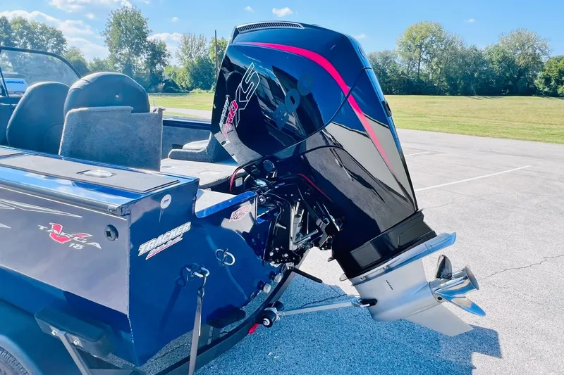 Slide: The Image of 2024 Tracker Targa V-18 Combo boat with powerful outboard motor in a sunny outdoor setting. - 8
