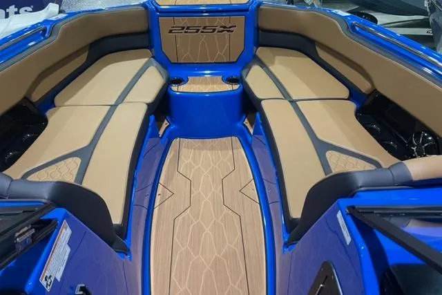 Slide: The Image of 2024 Yamaha Boats 255XD interior with tan seating and blue accents. - 10