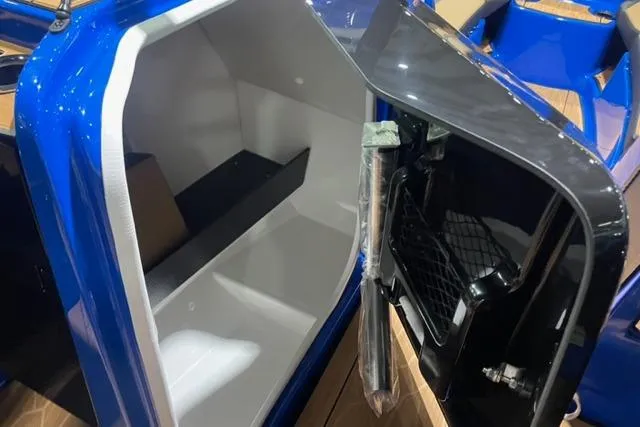 Slide: The Image of 2024 Yamaha Boats 255XD storage compartment with open hatch, showcasing interior space and design. - 11