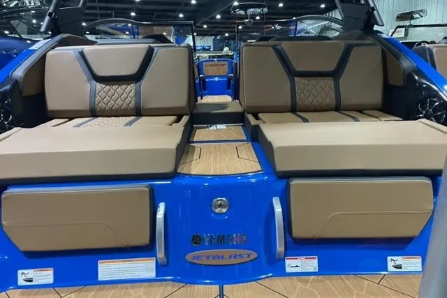 Slide: The Image of 2024 Yamaha Boats 255XD interior with tan seating and blue accents. - 4