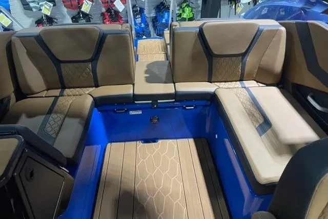 Slide: The Image of 2024 Yamaha Boats 255XD interior with brown seating and blue accents. - 7