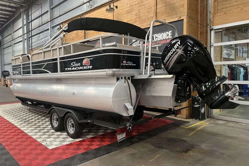 The Image of 2018 Sun Tracker SportFish 22 XP3 pontoon boat with Mercury outboard motor in showroom. - 1