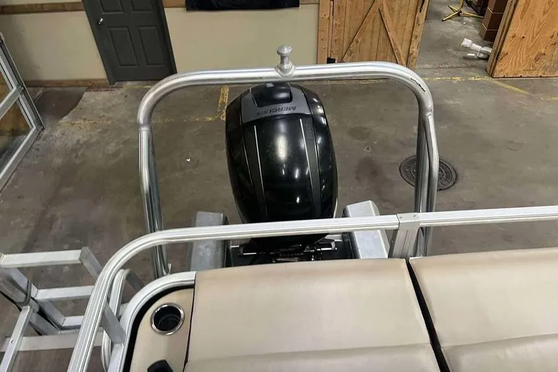 Slide: The Image of 2018 Sun Tracker SportFish 22 XP3 boat with Mercury outboard motor in a garage setting. - 5
