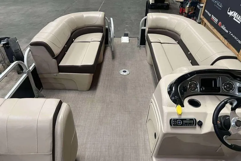 Slide: The Image of 2018 Sun Tracker SportFish 22 XP3 pontoon boat interior with beige seating and control console. - 6