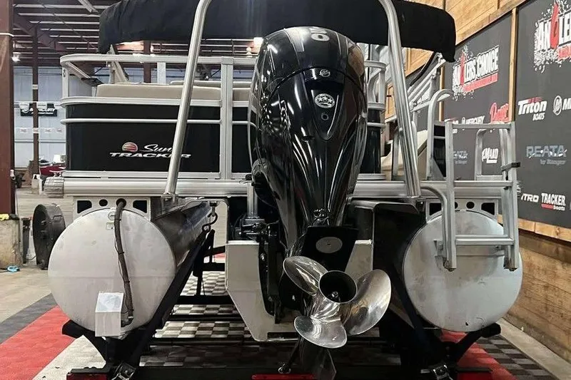 Slide: The Image of 2018 Sun Tracker SportFish 22 XP3 pontoon boat with powerful outboard motor in showroom. - 7