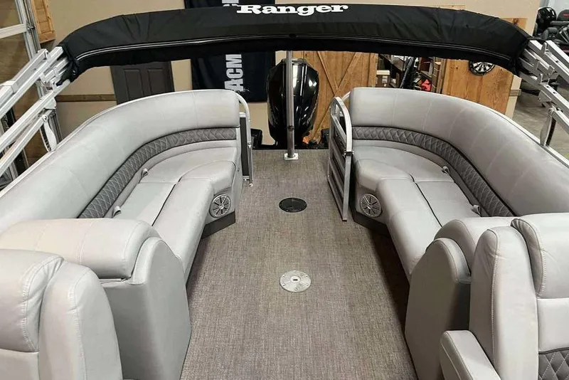 Slide: The Image of 2021 Ranger 243C pontoon boat interior with gray seating and canopy. - 3