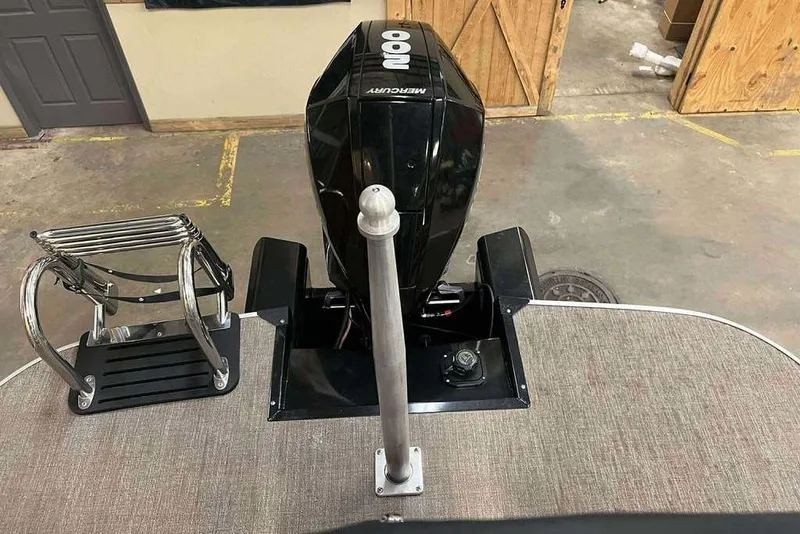 Slide: The Image of Ranger 243C boat with Mercury outboard motor in a garage setting, 2021 model. - 9