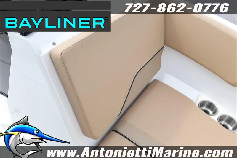 Slide: The Image of 2026 Bayliner V20 boat interior with beige seating, cup holders, and branding details. - 12