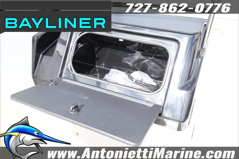 Slide: The Image of Open storage compartment on 2026 Bayliner V20 boat, featuring sleek design and accessories. - 24