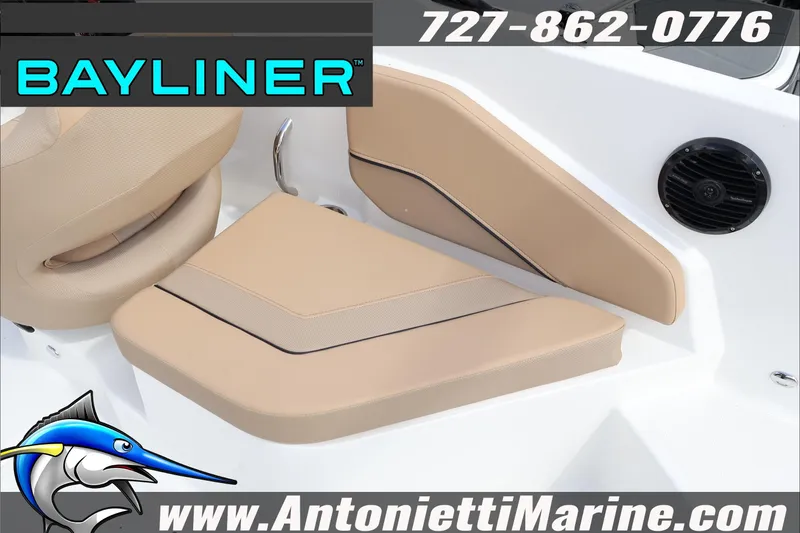 Slide: The Image of 2026 Bayliner V20 boat interior seating with beige cushions and speaker. - 29