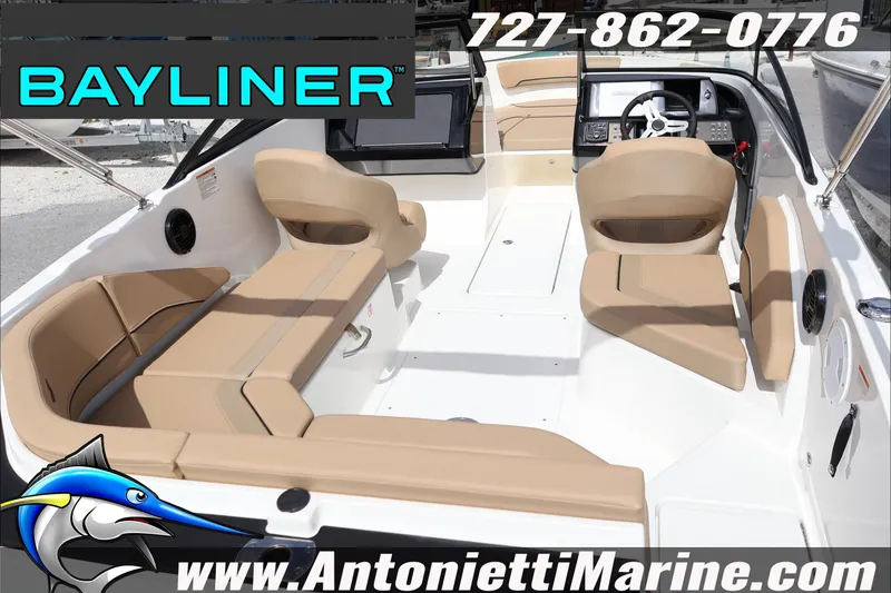 Slide: The Image of 2026 Bayliner V20 boat interior with beige seating, steering console, and marine branding. - 9