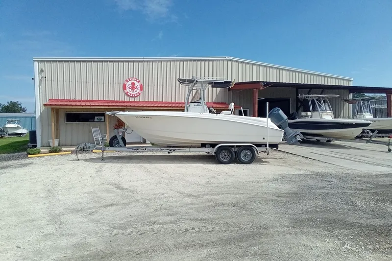 Slide: The Image of 2006 Wellcraft 232 Fisherman boat on trailer outside a marine warehouse. - 1