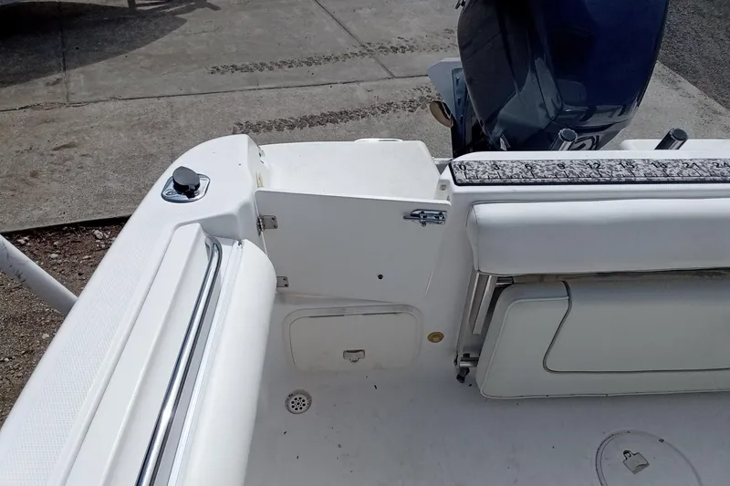 Slide: The Image of 2006 Wellcraft 232 Fisherman boat interior with seating and engine view. - 11