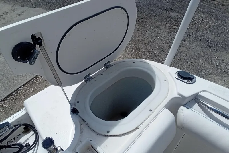 Slide: The Image of Open storage compartment on 2006 Wellcraft 232 Fisherman boat, showing interior details. - 13