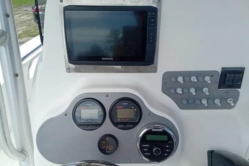 Slide: The Image of Control panel of a 2006 Wellcraft 232 Fisherman boat with Garmin display and gauges. - 15