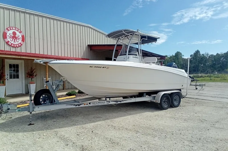 Slide: The Image of 2006 Wellcraft 232 Fisherman boat on trailer outside a building with "First Mates" sign. - 2