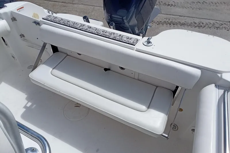 Slide: The Image of 2006 Wellcraft 232 Fisherman boat interior with white cushioned seating. - 22
