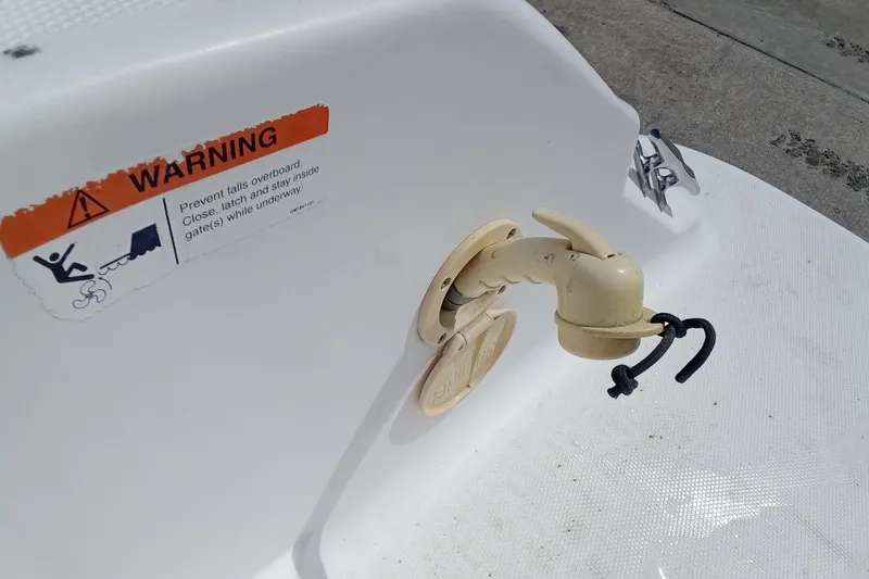 Slide: The Image of 2006 Wellcraft 232 Fisherman boat detail with safety warning label and hook. - 24