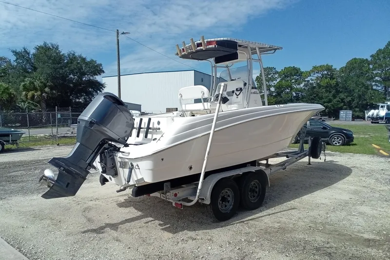 Slide: The Image of 2006 Wellcraft 232 Fisherman boat on trailer, parked outdoors under a clear sky. - 5