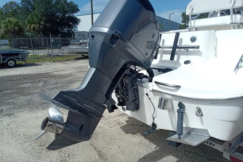 Slide: The Image of 2006 Wellcraft 232 Fisherman boat with outboard motor, parked on gravel. - 6