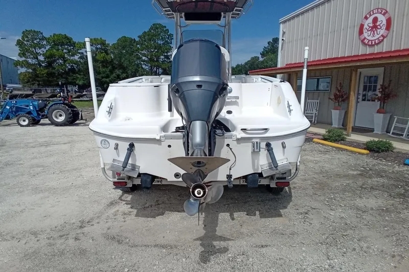Slide: The Image of 2006 Wellcraft 232 Fisherman boat with outboard motor, parked outdoors. - 7