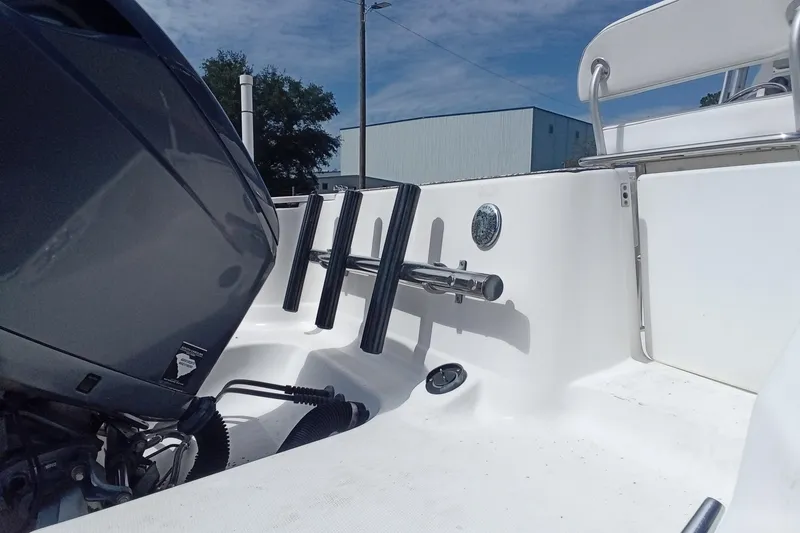 Slide: The Image of 2006 Wellcraft 232 Fisherman boat interior with motor and rod holders. - 9