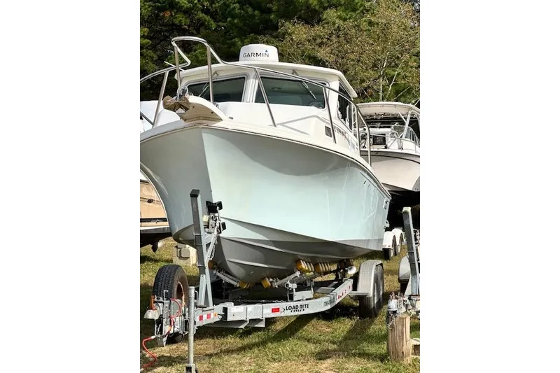 Slide: The Image of 2020 Parker 2520 XLD Sport Cabin boat on trailer, outdoors, with Garmin equipment. - 11