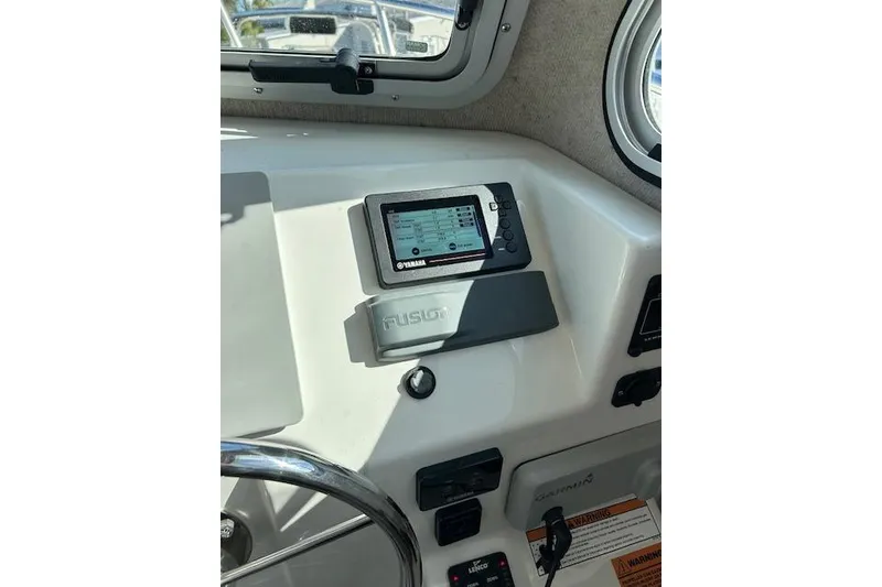 Slide: The Image of 2020 Parker 2520 XLD Sport Cabin dashboard with Yamaha display and Fusion audio system. - 13