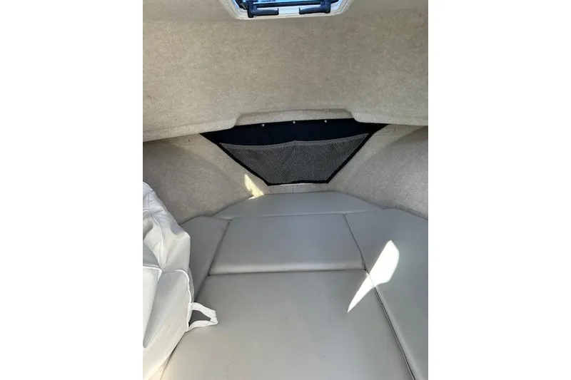 Slide: The Image of Interior cabin of 2020 Parker 2520 XLD Sport Cabin boat, featuring cushioned seating. - 6