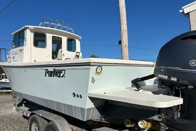 Slide: The Image of 2020 Parker 2520 XLD Sport Cabin boat on trailer, featuring Yamaha outboard motor. - 9