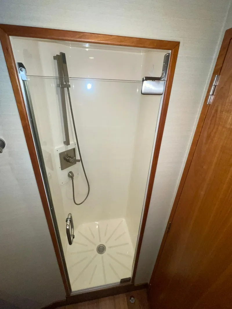 Slide: The Image of Shower cabin in 2013 Hatteras GT63 yacht, featuring glass door and modern fixtures. - 13