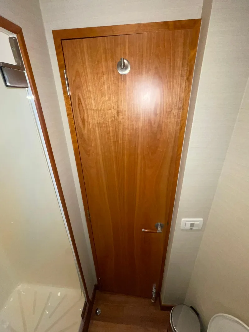Slide: The Image of Wooden door in 2013 Hatteras GT63 yacht interior, featuring sleek design and modern fixtures. - 16
