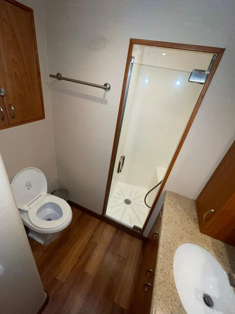 Slide: The Image of 2013 Hatteras GT63 yacht bathroom with shower, toilet, and sink. - 20