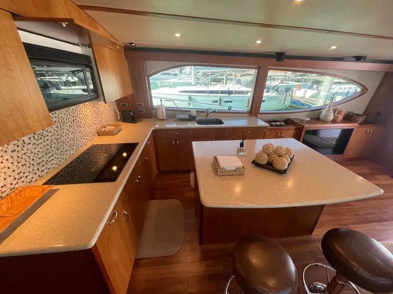 Slide: The Image of Luxurious 2013 Hatteras GT63 yacht kitchen with modern amenities and elegant design. - 38