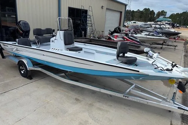 The Image of 2026 Xpress H22B Bay boat on trailer, parked outside a warehouse. - 1