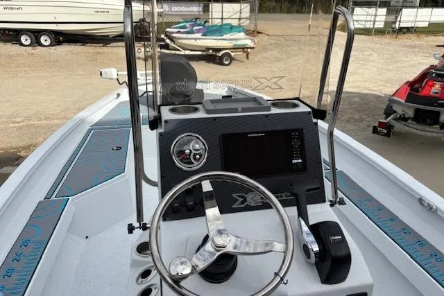 Slide: The Image of 2026 Xpress H22B Bay boat dashboard with steering wheel and controls. - 14