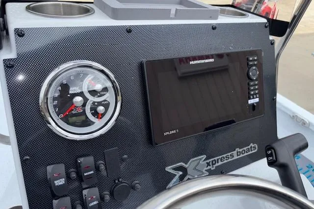 Slide: The Image of 2026 Xpress H22B Bay boat dashboard with gauges and Humminbird Xplore 9 display. - 15