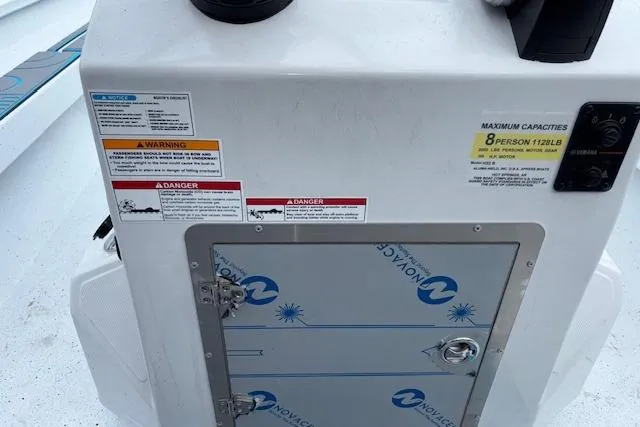 Slide: The Image of 2026 Xpress H22B Bay boat console with safety warnings and capacity details. - 17