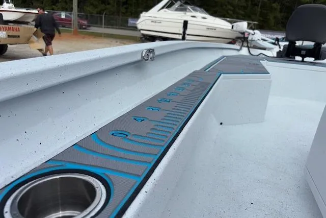 Slide: The Image of 2026 Xpress H22B Bay boat deck with built-in measuring ruler and cup holder. - 18