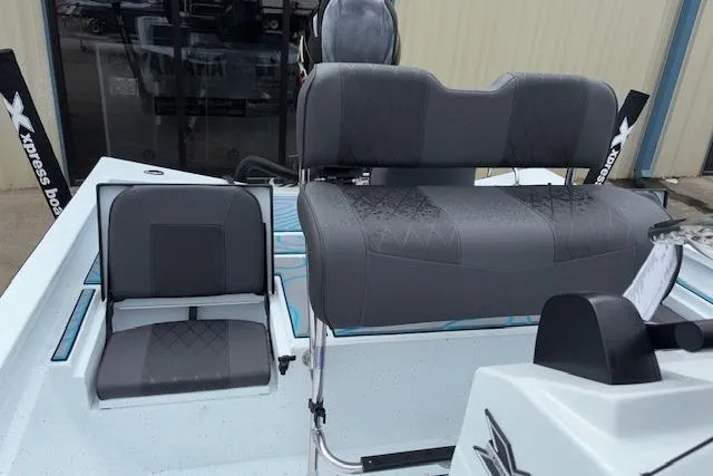 Slide: The Image of 2026 Xpress H22B Bay boat interior with gray seating and modern design. - 22