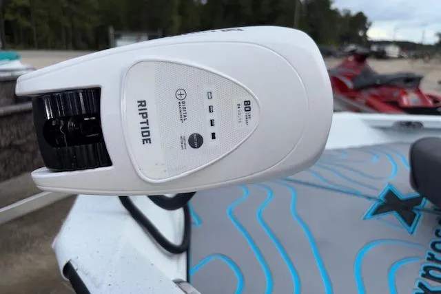 Slide: The Image of 2026 Xpress H22B Bay boat with Riptide motor, docked near watercraft. - 23