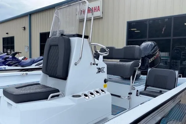 Slide: The Image of 2026 Xpress H22B Bay boat with Yamaha engine, displayed outside a dealership. - 5