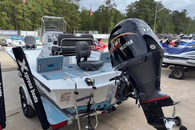 Slide: The Image of 2026 Xpress H22B Bay boat with Yamaha 175 engine, parked outdoors. - 6