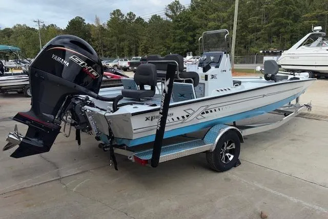 Slide: The Image of 2026 Xpress H22B Bay boat with Yamaha engine on a trailer, parked outdoors. - 8