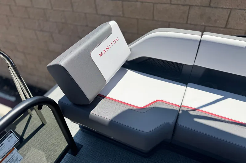 Slide: The Image of 2025 Manitou Cruise 20 boat seat with gray and white upholstery, red accents. - 13
