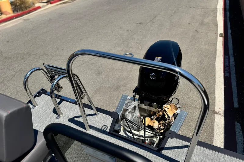 Slide: The Image of 2025 Manitou Cruise 20 pontoon boat with outboard motor on a sunny day. - 15