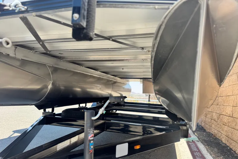 Slide: The Image of Underneath view of 2025 Manitou Cruise 20 pontoon boat on a trailer. - 3