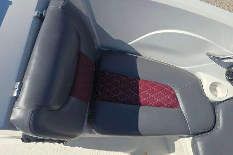 Slide: The Image of Gray and maroon seat in 2016 Tahoe 500 TS boat, featuring diamond stitching. - 10