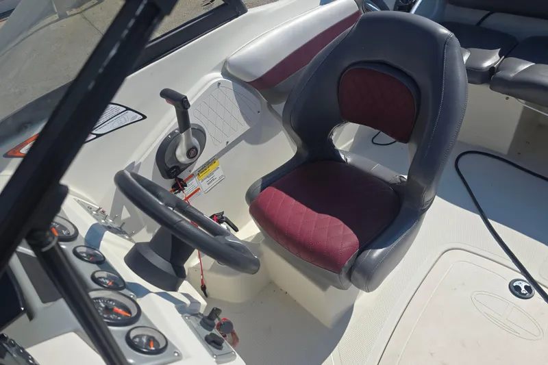 Slide: The Image of 2016 Tahoe 500 TS boat interior with steering wheel and maroon seat. - 12